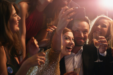 Selfie, party and new year with friends in a nightclub posing for photograph of celebration...