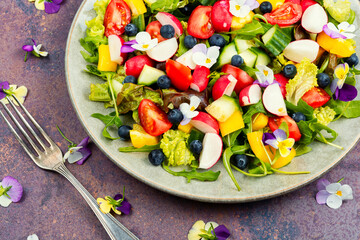 Tasty summer salad with edible flowers