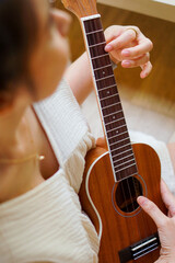 hand playing ukulele