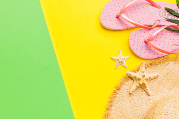 Summer vacation concept flat lay. straw hat beach accessories and flip flop top view. Space for...