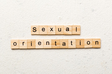 Sexual orientation word written on wood block. Sexual orientation text on cement table for your desing, concept