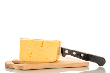 A piece of cheese with a metal knife on a wooden kitchen board, macro, isolated on a white background.