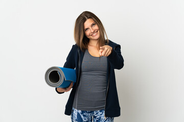 Slovak girl going to yoga classes isolated on white background pointing front with happy expression