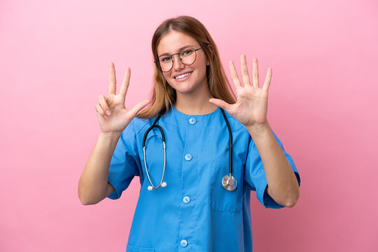 Young surgeon doctor woman isolated on pink background counting eight with fingers