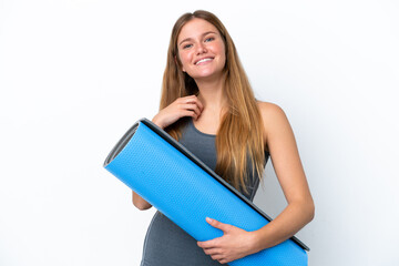 Young sport woman going to yoga classes while holding a mat laughing