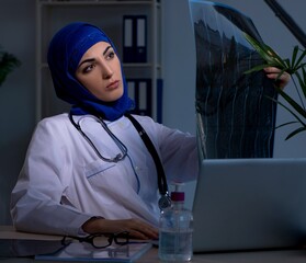 Arab female doctor working in the clinic at night