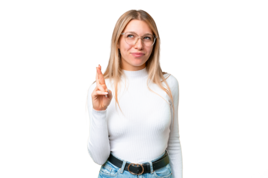 Young pretty blonde woman over isolated chroma key background with fingers crossing and wishing the best