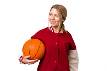 Young hispanic woman playing basketball over isolated white background looking to the side and smiling