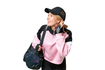 Pretty sport woman with sport bag over isolated chroma key background listening to something by putting hand on the ear