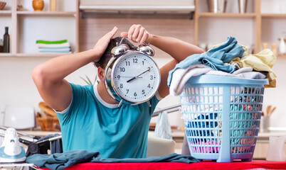 Young man husband doing clothing ironing at home