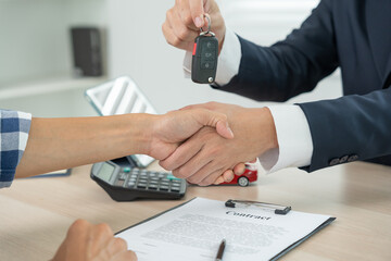 lease, rental car, sell, buy. Dealership manager send car keys to the new owner.  Sales, loan...