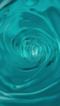 Whirlpool or funnel in water. macro shooting, slow motion. turquoise sea color water Vertical video. Vertical video.