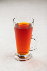 Glass mug of hot black tea