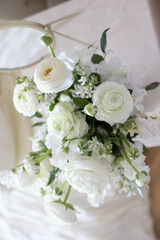 Bouquet of white flowers in female hands