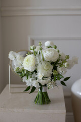 Wedding bouquet on table. White flowers and ranunculus.