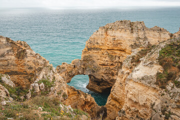 Famous tourist destination of Ponta da Piedade on the southern peninsula of Lagos in the Algarve region of Portugal. Cape of yellow-gold cliffs during the afternoon