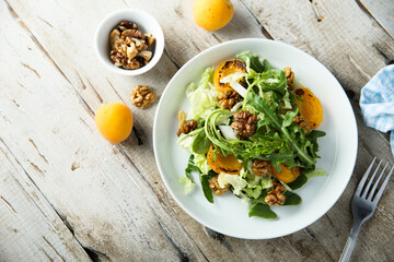 Healthy leaf salad with apricot and walnut
