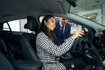 Young customer is happy to inspect the car before buying