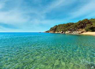 Mediterranean sea rocky coast summer view with sandy beach (Costa Brava, Catalonia, Spain.