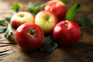 Delicious red apples with green leaves