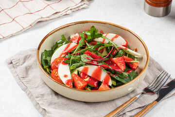 Portion of healthy colorful salad with strawberry and greens