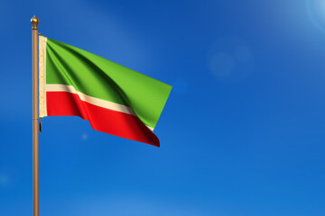 Chechen Republic. Flag blown by the wind with blue sky in the background.