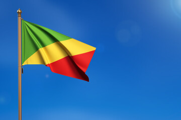 Congo, Republic of the Congo. Flag blown by the wind with blue sky in the background.