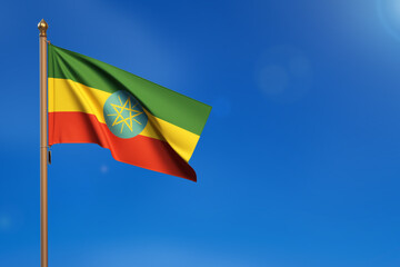 Ethiopia. Flag blown by the wind with blue sky in the background.