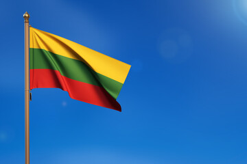 Lithuania. Flag blown by the wind with blue sky in the background.