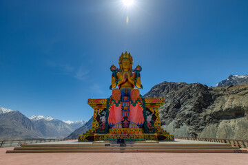 Big Sitting Buddha Statue at Diskit Monastery with Himalaya Range in the back - Nubra Valley,...