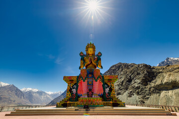 Big Sitting Buddha Statue at Diskit Monastery with Himalaya Range in the back - Nubra Valley, Ladakh, India
