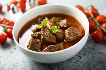 Homemade beef goulash with fresh basil