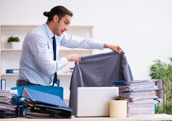 Young male employee unhappy with excessive work