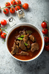 Homemade beef goulash with fresh basil