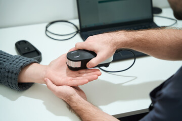Nutritionist conducts an oligoscan procedure at the workplace
