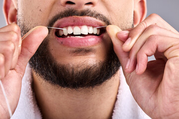 Mouth, man and flossing teeth for dental health in studio isolated on a white background. Closeup, floss and male model cleaning tooth for oral wellness, hygiene and healthy product for fresh breath.