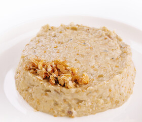 Oatmeal porrige in white plate isolated