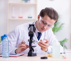 Young male chemist experimenting in lab