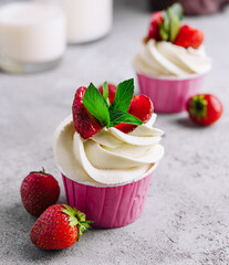 Vanilla cupcake with white cream and strawberries
