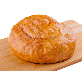 Fresh twisted bun on wooden board