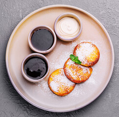 Cottage pancakes with berry jam, sour cream