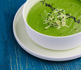 Plate of broccoli and green peas cream soup