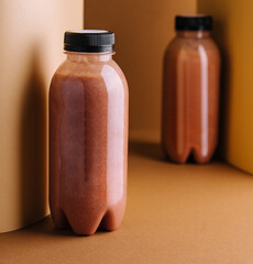 chocolate smoothies milkshake in bottles on brown background