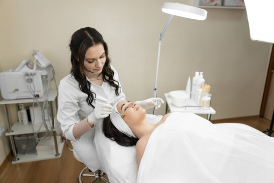The photo reflects the magical atmosphere and gentle process of facial skin peeling, which improves the skin of the face and gives well-being to beauty, youth and confidence in the beauty salon