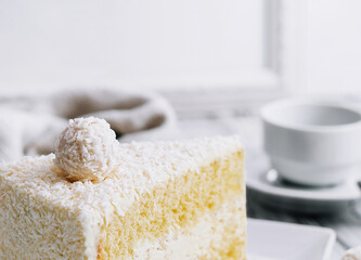 Coconut layered, raffaello cake on white plate