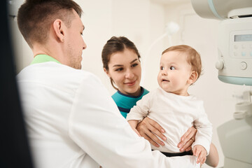 Radiologist getting infant ready for radiography procedure