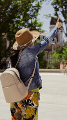 young female tourist in front of a statue in a plaza
