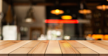 Wooden top table on blur restaurant background.