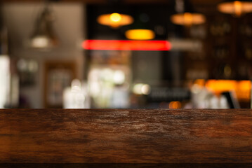 Wooden top table on blur restaurant background.