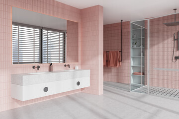 Fototapeta na wymiar Pink tile bathroom corner with double sink and shower stall